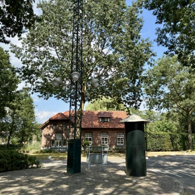 Plein met bakkerij, slagerij, dorpspomp en straatlantaarn